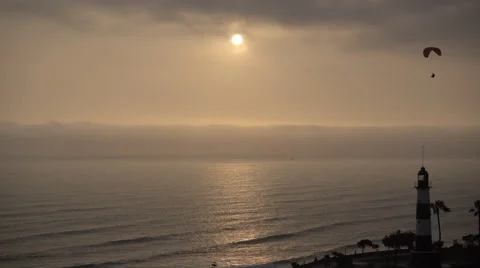 Lima Lighthouse Paragliders over the ocean at sunset Stock-Footage 68785136