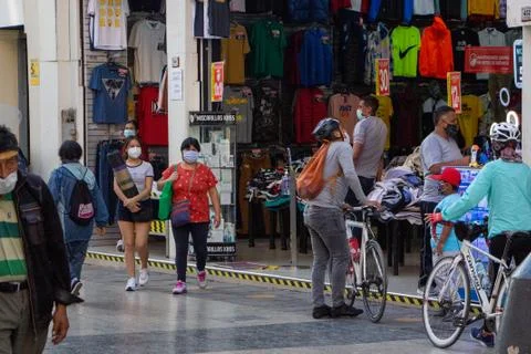 LIMA, PERU - 11/03/2020: Cyclists shopping in Lima during the Covid-19 Stock Photos