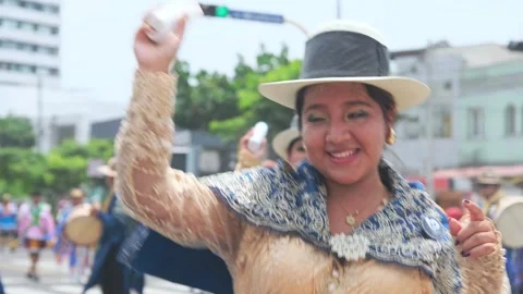 Lima, Peru. March, 1 2026; Peruvian woman dancing in an andean carnival parade Stock Footage 330255441