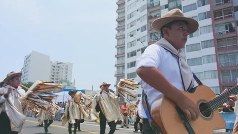 Lima, Peru. March, 1 2026; Peruvian musician playing guitar during andean Stock Footage 330255570