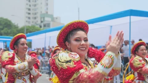 Lima, Peru. March, 1 2026; Joyful woman dancing in andean carnival parade Stock Footage 330255864