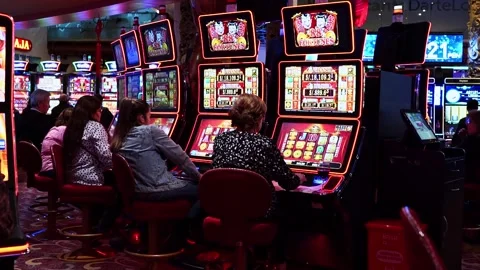 Lima, Peru, October 31, 2023: People playing slot machines Stockbeeldmateriaal 322081328