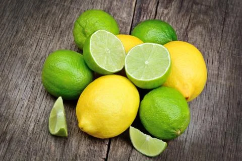 Lime and lemon on a rustic table Foto stock