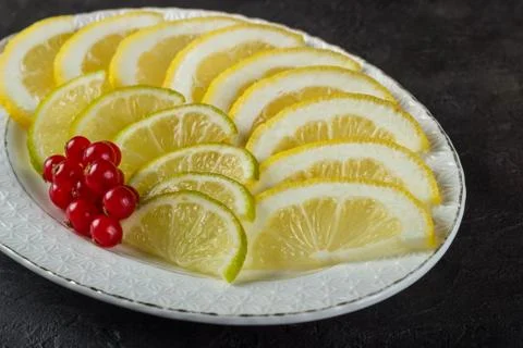 Lime and lemon snack with currant sprig Stock Photos