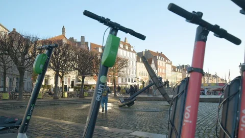 Lime and Voli electric sharing scooters baked in Copenhagen, Denmark Stock Footage 128722391