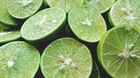 Lime Background with sun light from outside. Close up shot of limes. Stock Photos