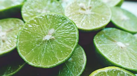 Lime Background with sun light from outside. Close up shot of limes. Foto stock