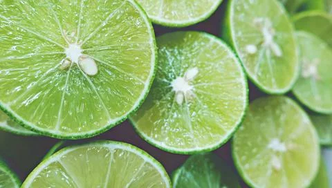Lime Background with sun light from outside. Close up shot of limes. Stock Photos