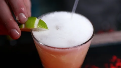 Lime Being added to a cocktail Stock Footage 102009422