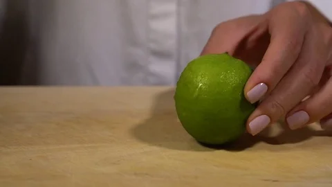 Lime being cut on chopping board Stock Footage 79473370