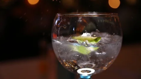 Lime being dropped into a Cocktail Stock Footage 102010285