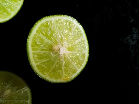 Lime on black background Stock Photos