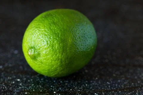 Lime on a black marble desk Stock Photos