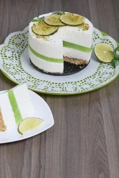 Lime cheesecake without baking. Decorated with lime slices. The piece is cut  Stock Photos