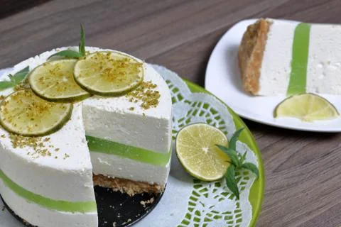 Lime cheesecake without baking. Decorated with lime slices. The piece is cut  Stock Photos