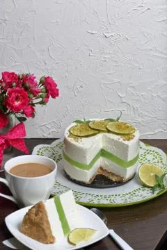 Lime cheesecake without baking. The piece is cut off. Lies on a plate. Near a Stock Photos
