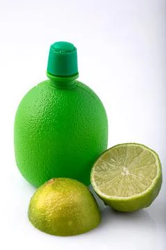 Lime concentrate bottle with lime slice Stock Photos