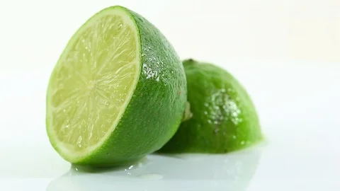 A lime cut in half and arranged on a white background Stock Footage 87857105