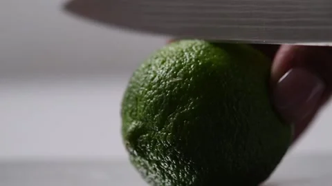 Lime cut with a knife in half Stock Footage 131978143