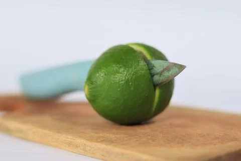 Lime on a cutting board split with a knife Stock Photos
