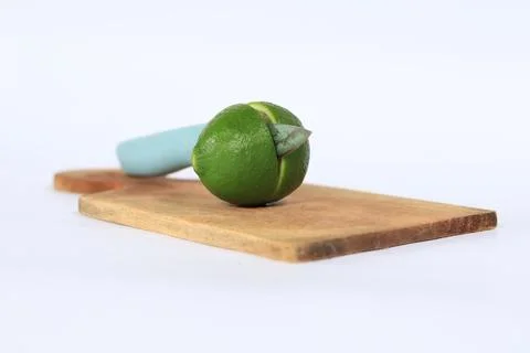 Lime on a cutting board split with a knife Stock Photos
