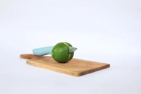 Lime on a cutting board split with a knife Stock Photos