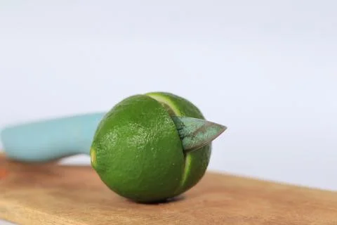 Lime on a cutting board split with a knife Stock Photos