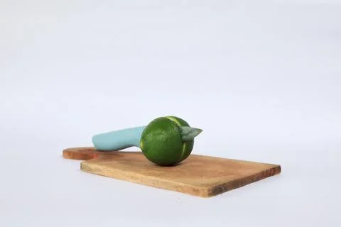 Lime on a cutting board split with a knife Stock Photos