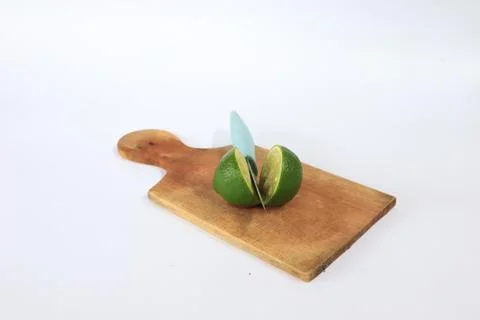 Lime on a cutting board split with a knife Stock Photos