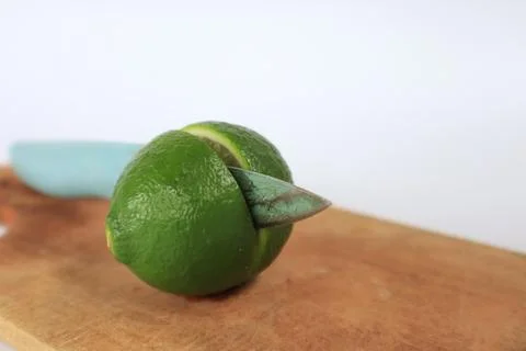 Lime on a cutting board split with a knife Stock Photos