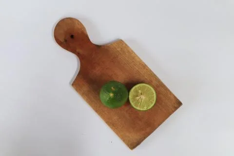 Lime on a cutting board split with a knife Stock Photos