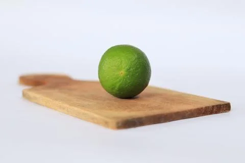 Lime on a cutting board with a white background Stock Photos