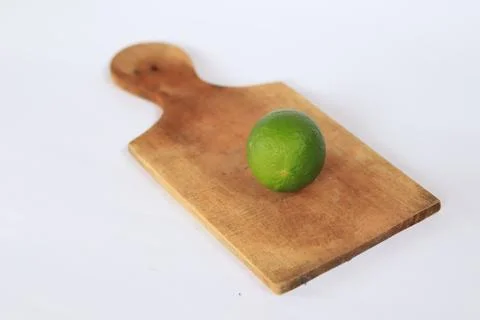 Lime on a cutting board with a white background Stock Photos