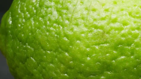 Lime on a dark background. Macro. Ripe citrus. 4K. Stock Footage 140473411