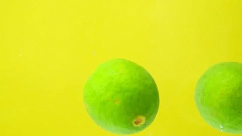 Lime Dropped Into Water. Citrus Bubbles Splashing Slow Motion Stock Footage 308456683