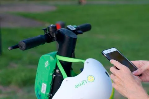 Lime e-scooter handlebar and mobile phone ready for scan Stock Photos