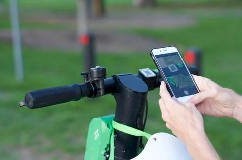 Lime e-scooter handlebar and mobile phone ready for scan Stock Photos