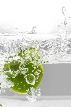 Lime Falling into Water Splash Stock Photos
