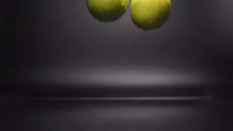 Lime Falling in Water with Splash in Slow Motion Stock Footage 104724872
