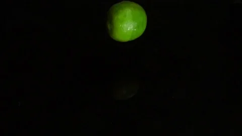Lime falls into the water, slow motion Stock Footage 84913407