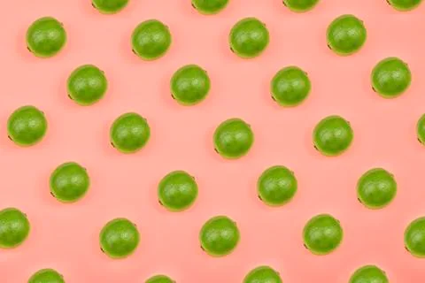 Lime fruit piece pattern isolated on salmon background. Composition. Stock Photos