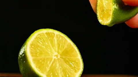 Lime green Lemon cut with a knife and squeeze out the lemon juice with his hands Stock Footage