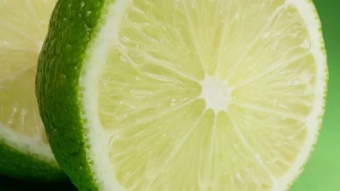 Lime halves on a green background. Citrus fruit. Macro. Stock Footage 140472047