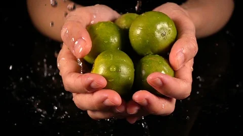 Lime in hands with water drop Stock Footage 88615770