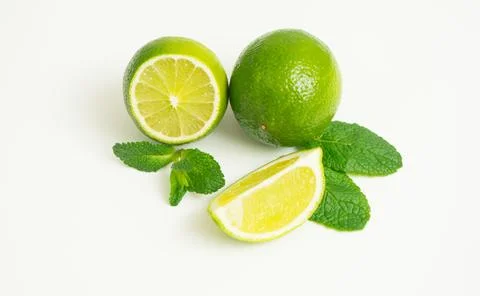 Lime isolated. Lime slice with mint leaves isolate on white. Stock Photos