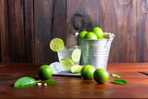 Lime juice or lime lemonade or green lemon with lemon tank on wooden table. Stock Photos