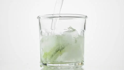 Lime, mint and ice falling then soda water pouring in the glass. Stock Footage 170616411