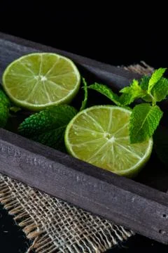 Lime with mint on rustic background Stock Photos