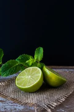 Lime with mint on rustic background Foto stock