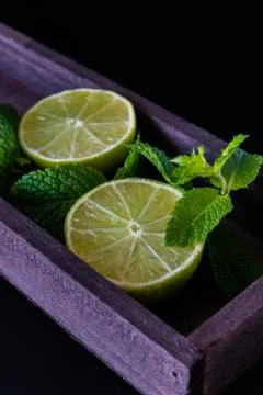 Lime with mint on rustic background Stock Photos